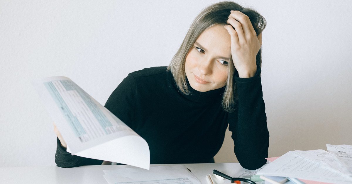 Woman looking stressed with paperwork for article on Silver Magazine www.silvermagazine.co.uk