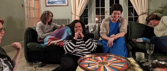 Group of women laughing and playing games on a friends holiday break