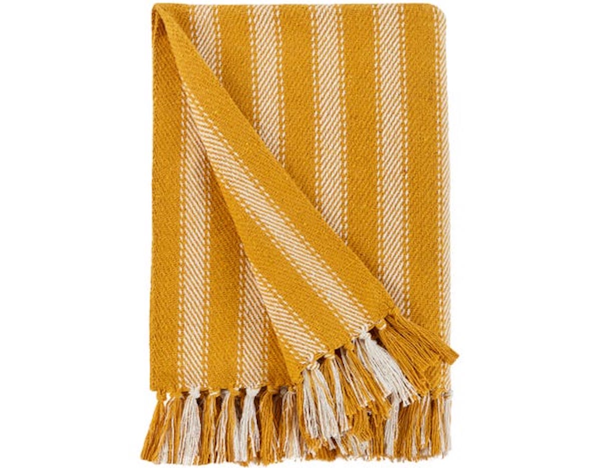 Folded yellow blanket with white vertical stripes and tassels. Best garden party essentials on Silver.