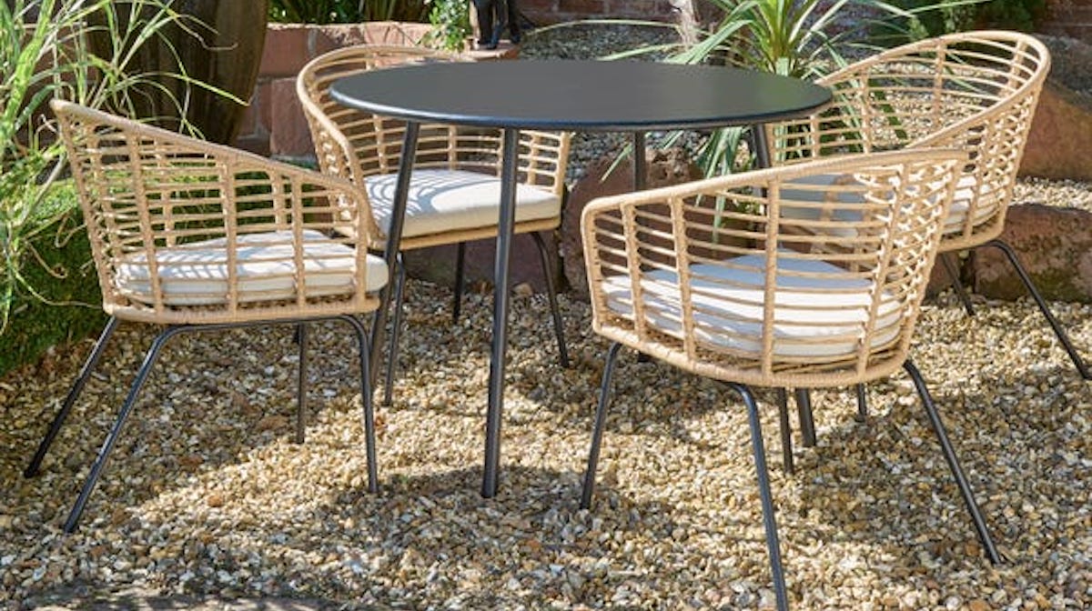 Round garden table and wicker chairs positioned around it. Best garden party essentials on Silver.