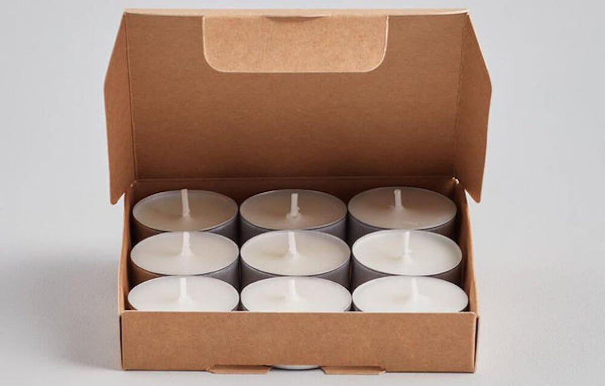 Cardboard box half open revealing nine tea light candles. Best garden party ideas for your guests on Silver Magazine - www.silvermagazine.co.uk