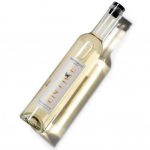 Clear bottle of Hattingley Valley Entice dessert wine with light yellow liquid, black top and white label, set on a white background
