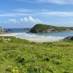 Panoramic view of a beach in Scotland surrounded by greenery.