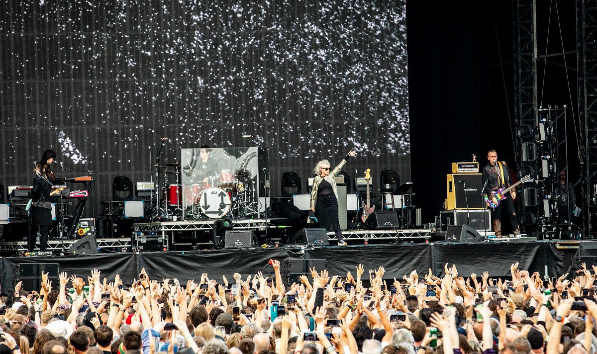Image shows long range shot of stage with band Blondie performing live