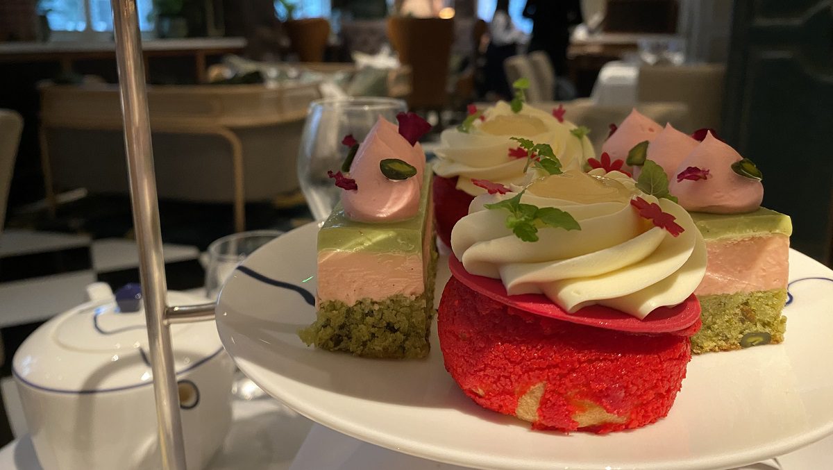 Image shows a close up of a plate of fancy cakes as part of an afternoon tea tower