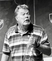 Black and white image of Roy Stevens on stage practicing theatre over 50