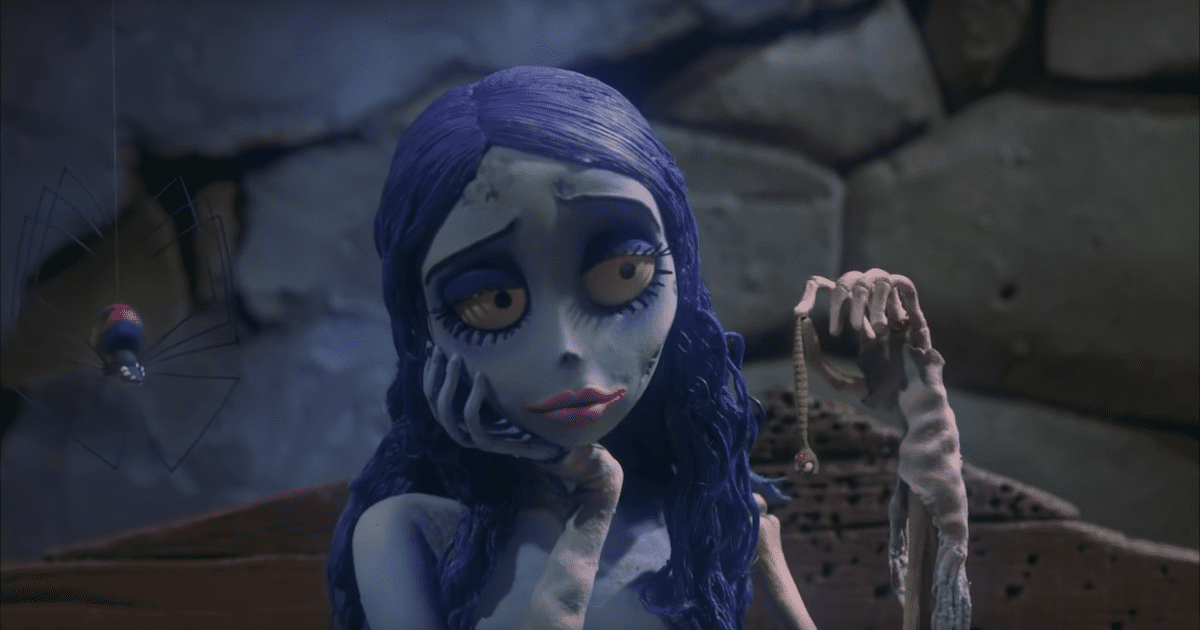 Close up still of stop motion character corpse bride, looking at a worm she's holding up. Halloween films not scary on Silver