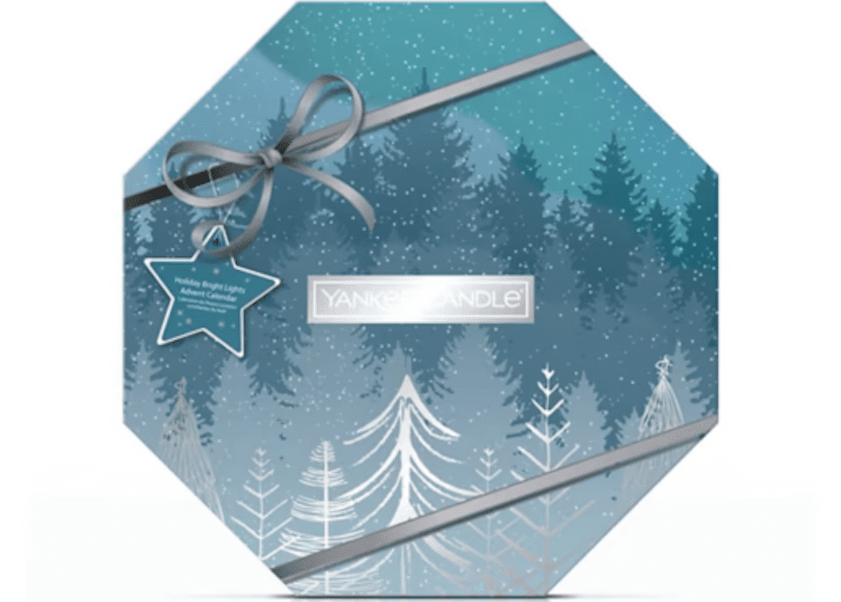 Blue hexagonal box with tree landscape on it and a printed bow.