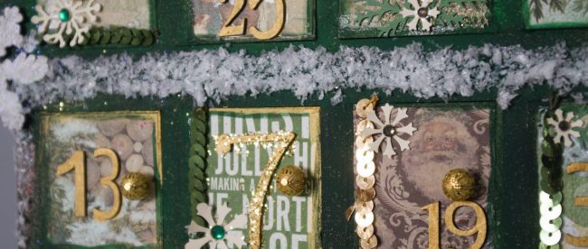 Close up of small green advent doors with numbers on them counting down to Christmas. Christmas advent calendars on Silver