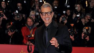 Jeff Goldblum smiling on the red carpet in navy and black suit. Men's Christmas party wear on Silver