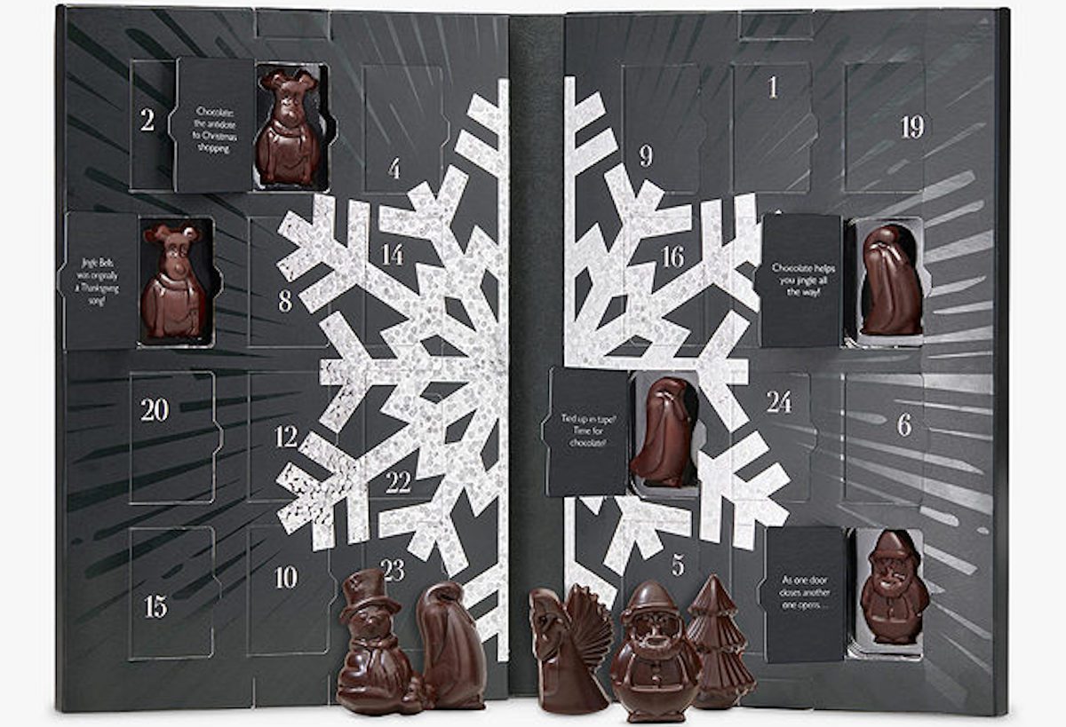 Hotel Chocolat advent calendar. Black calendar with a white snowflake printed on. Some doors are open with festive characters made from chocolate in. Christmas advent calendar roundup
