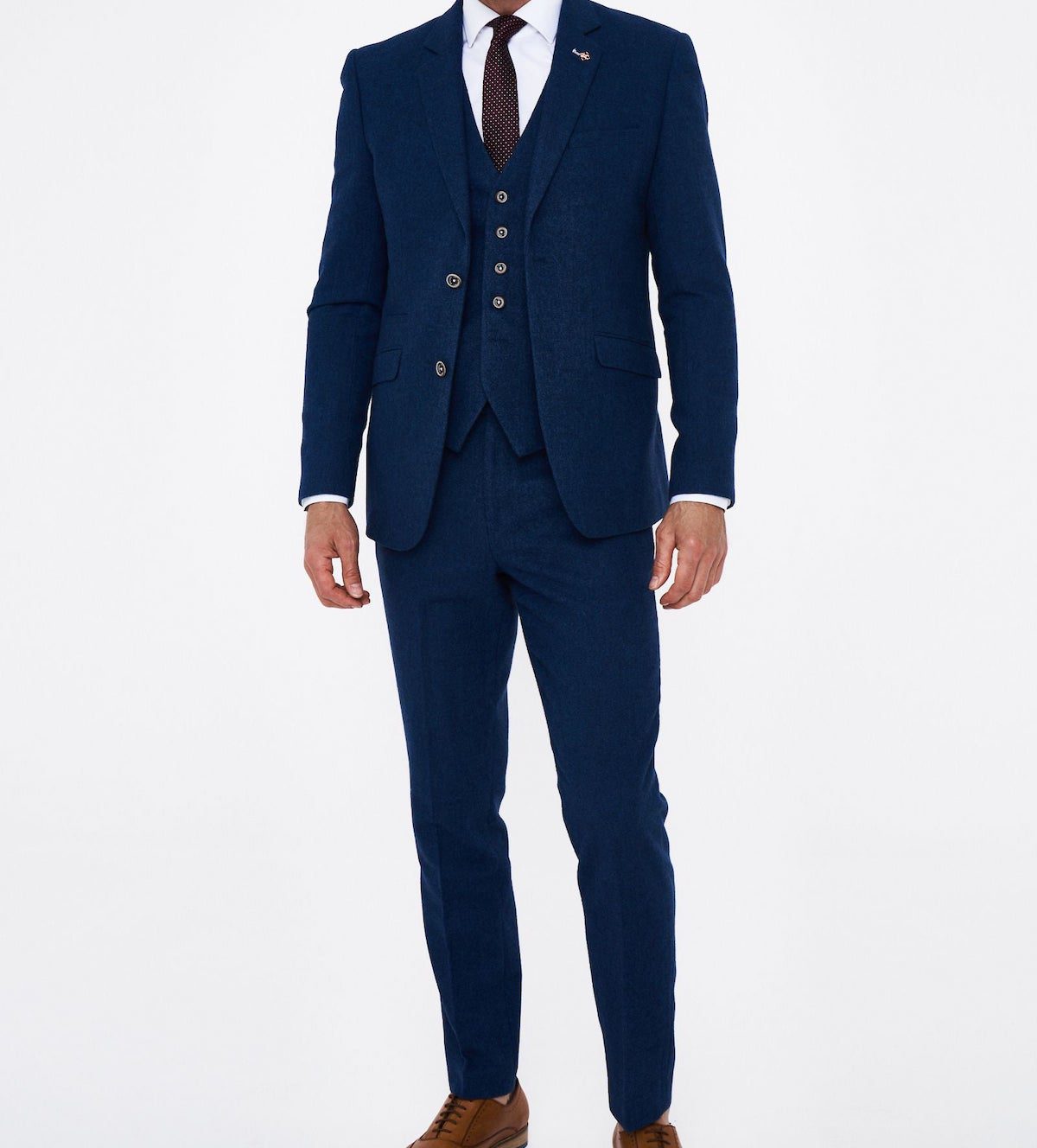 Model stood in navy blue three piece suit. Men's Christmas party wear