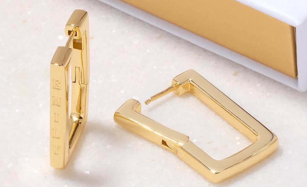 Square hoop earrings in gold with 'EMILY' engraved down one side of the square. Women's party wear ideas on Silver Magazine