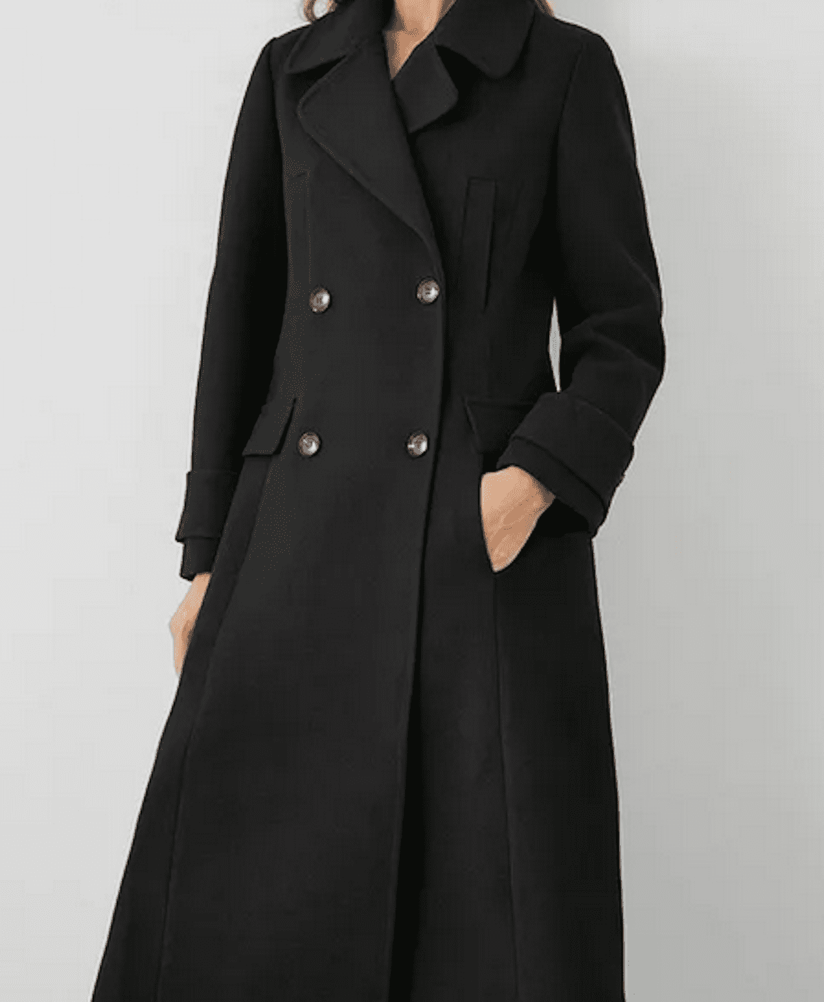 Black long line double breasted wool coat modelled against a grey background. Women's party wear