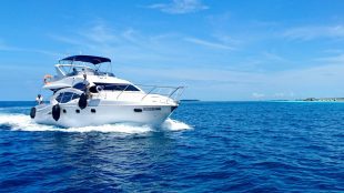A white yacht sailing through blue sea under blue skies. Yachting for beginners